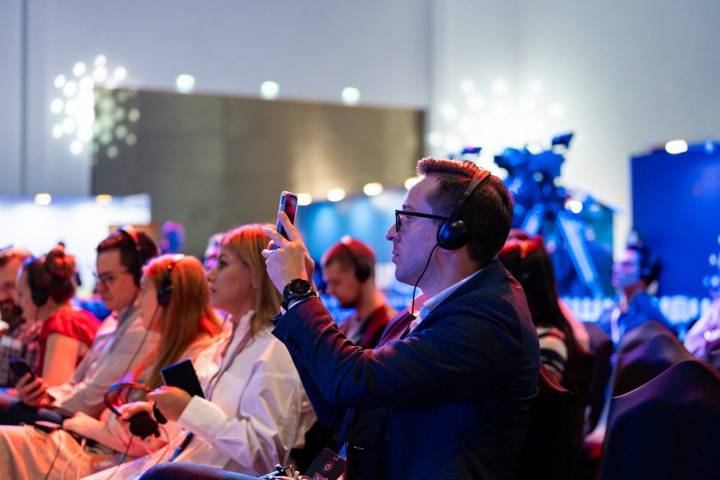 Immersive event experiences, event attendee wearing headphone during conference session