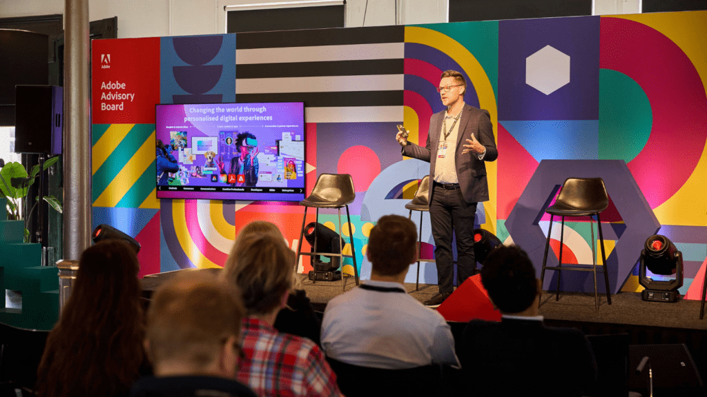 event conference host on stage with branded background