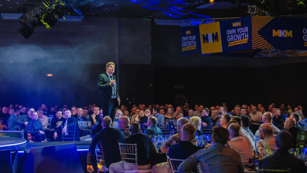 Strategic immersive leadership conference delivered by event agency with bold stage design, keynote speakers gala awards dinner.