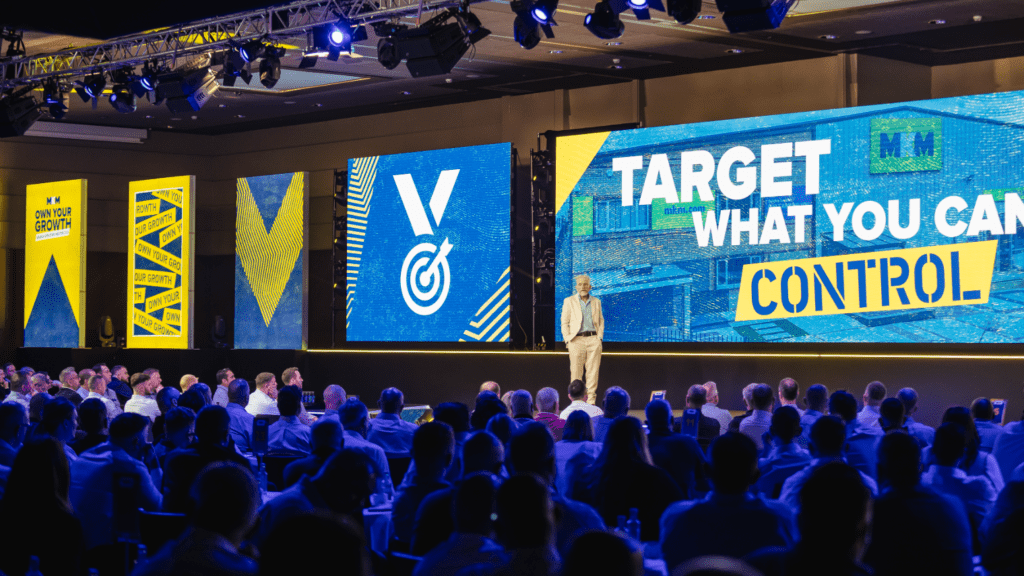 Strategic immersive leadership conference delivered by event agency with bold stage design, keynote speakers gala awards dinner.