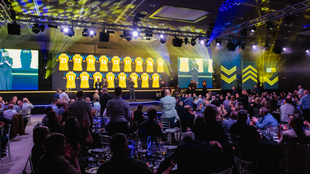 Strategic immersive leadership conference delivered by event agency with bold stage design, keynote speakers gala awards dinner.