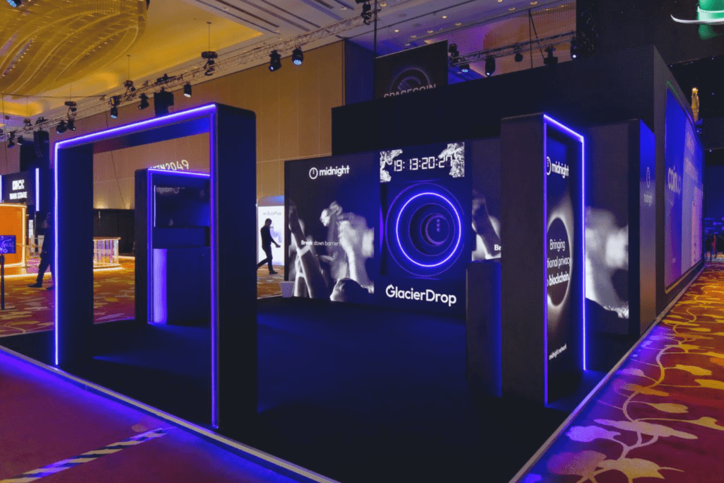 Bespoke exhibition stand with lighting and digital displays creating immersive brand experience by creative event agency