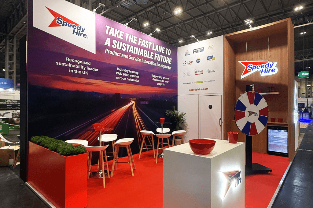 Bespoke exhibition stand with lighting and digital displays creating immersive brand experience by creative event agency