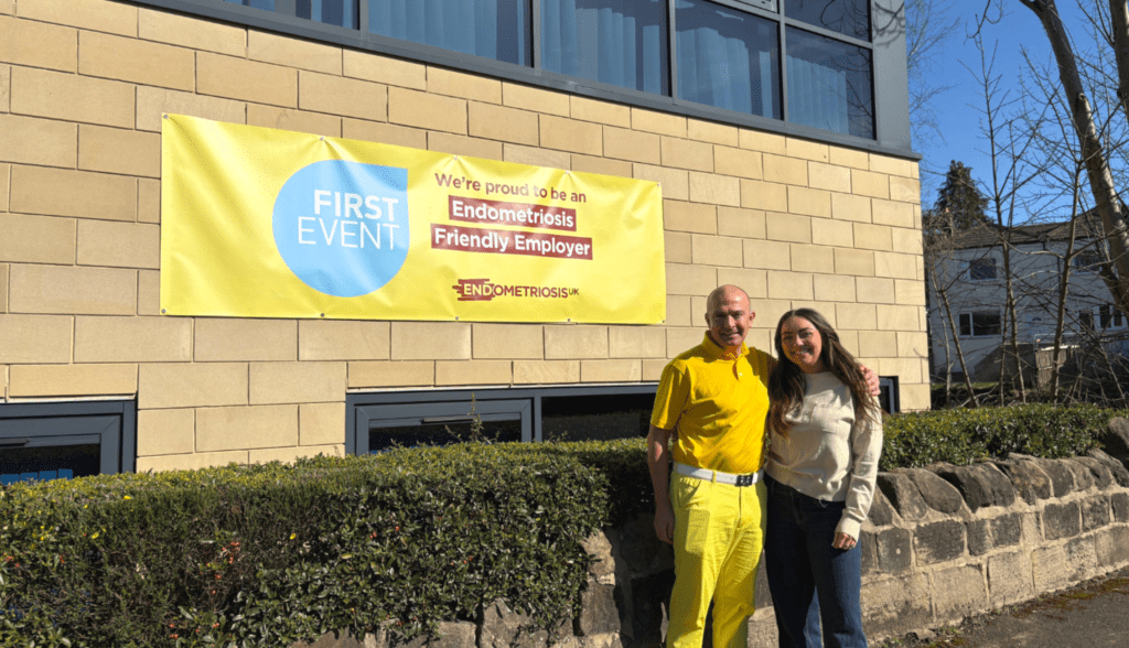 First Event team showing support for Endometriosis Awareness Month, wearing yellow and displaying office signs promoting awareness and solidarity.