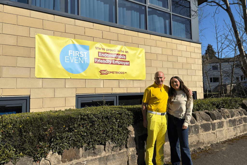First Event team showing support for Endometriosis Awareness Month, wearing yellow and displaying office signs promoting awareness and solidarity.